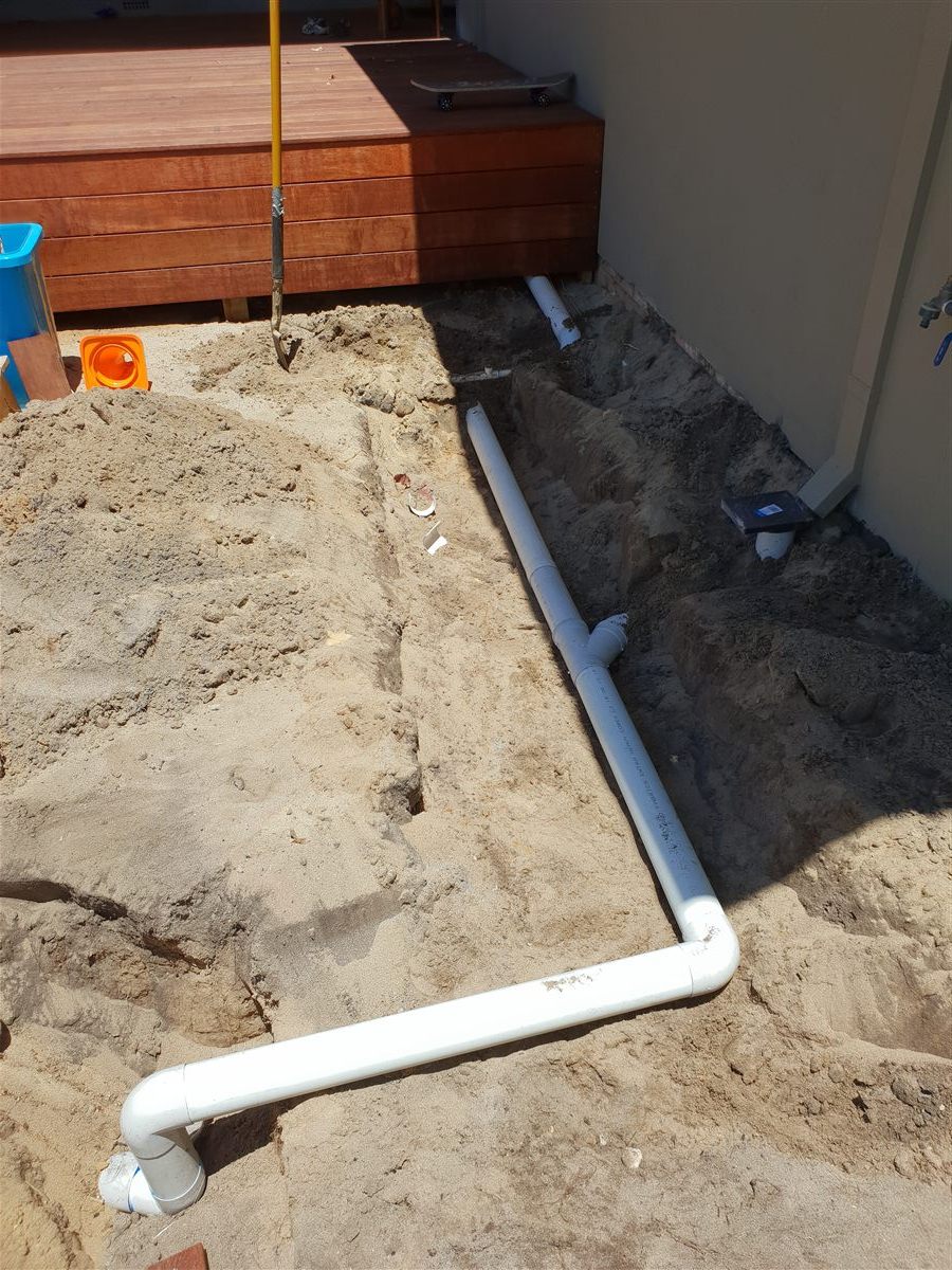 Stormwater piping installation trench with connected pipework running to the soakwell